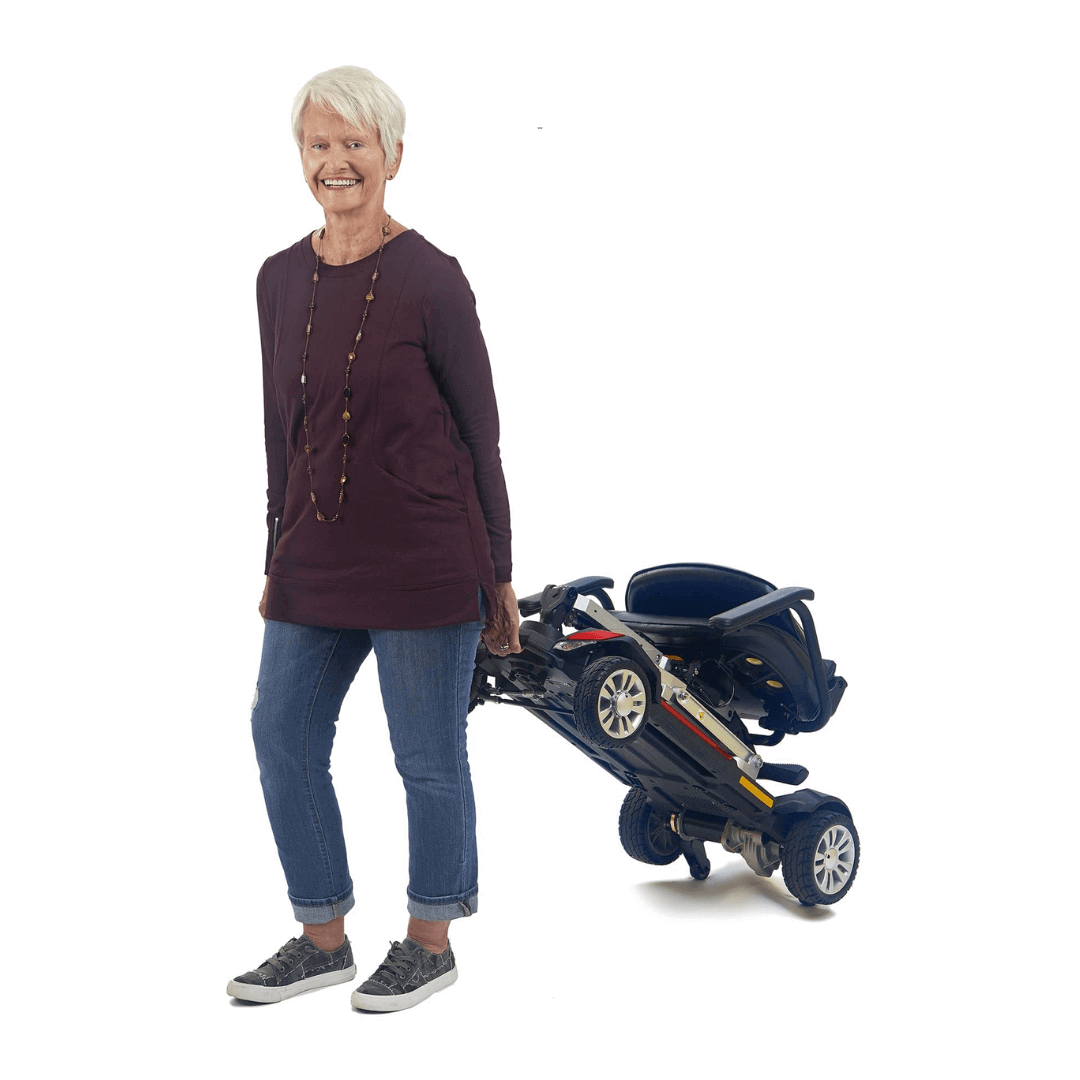 Golden Tech Buzzaround Carry-On Folding Travel Scooter with Travel Battery being transported by patient 2