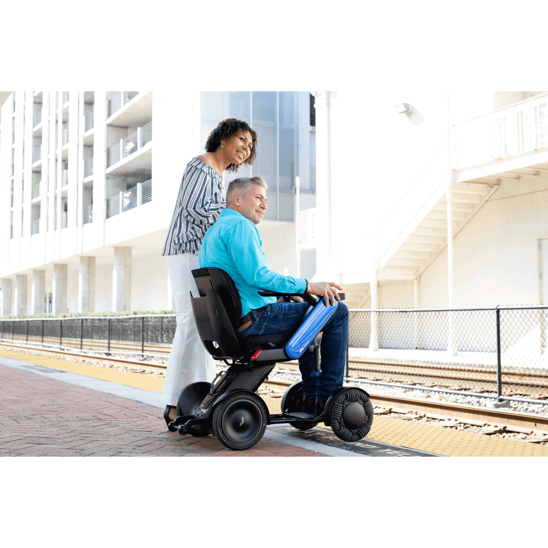 WHILL Model C2 Personal EV Smart Electric Vehicle - Intelligent Power Chair blue with patient