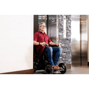 Whill C2 Premium Power Chair with patient going out of the elevator